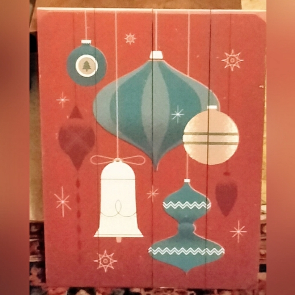 Hand painted wooden sign wall hanging Christmas decoration of ornaments.